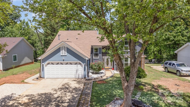 view of front of home with driveway, a front yard, and an attached garage