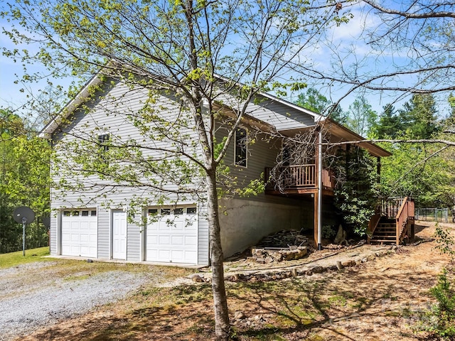 316 Big Raven Ln, Saluda, NC 28773 - view of side of home featuring dirt driveway, stairway, a garage, and a deck