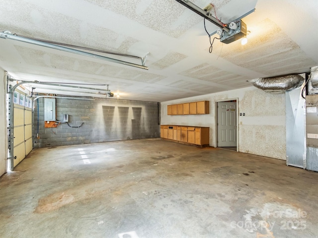 316 Big Raven Ln, Saluda, NC 28773 - garage with a garage door opener, electric panel, and concrete block wall