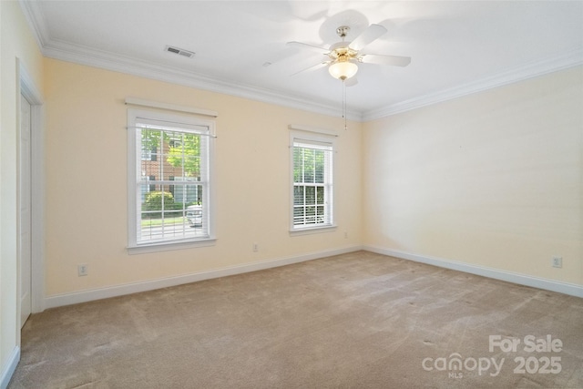 unfurnished room featuring ornamental molding, light carpet, and baseboards