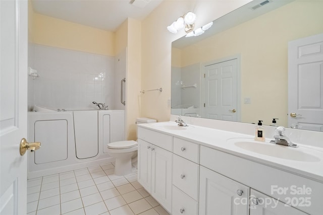 bathroom featuring a bath, tile patterned floors, visible vents, and a sink