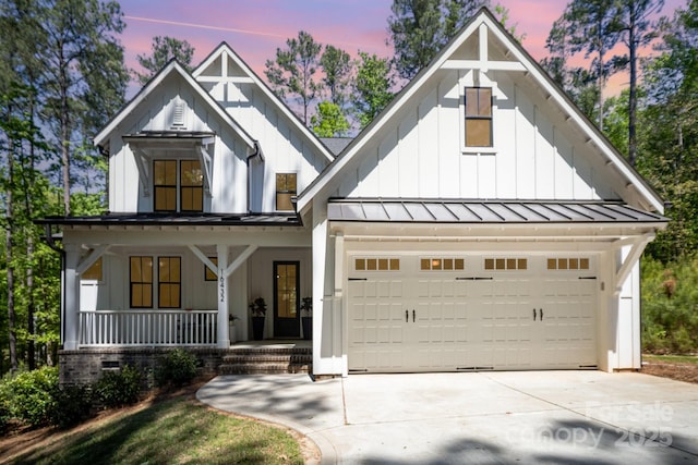 16432 Here At Last Ln, Charlotte, NC 28278 - modern farmhouse style home with a garage, board and batten siding, concrete driveway, a standing seam roof, and covered porch