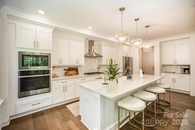 16432 Here At Last Ln, Charlotte, NC 28278 - kitchen featuring a notable chandelier, appliances with stainless steel finishes, light countertops, wall chimney exhaust hood, and decorative backsplash