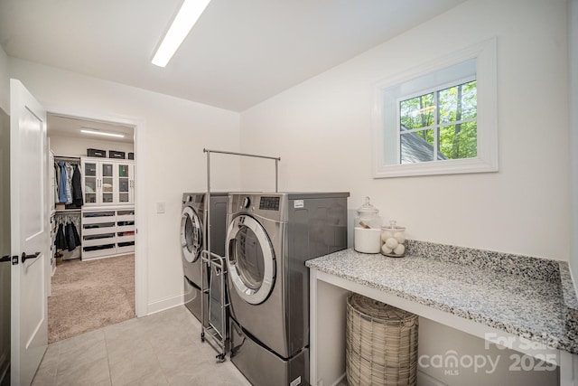 16432 Here At Last Ln, Charlotte, NC 28278 - laundry area with light tile patterned flooring, laundry area, light colored carpet, baseboards, and washing machine and dryer