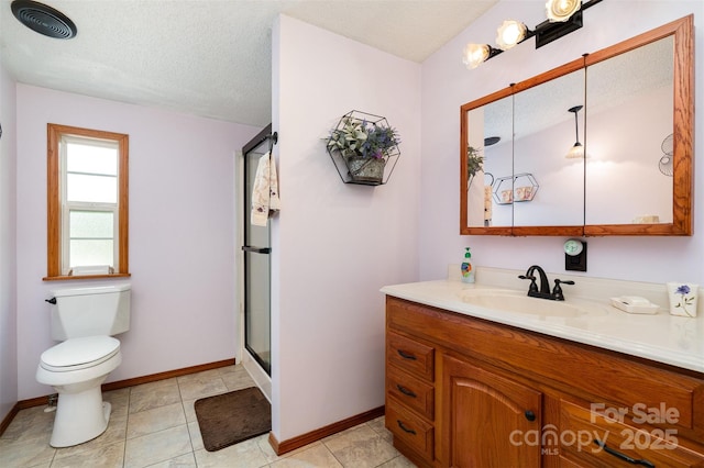 bathroom featuring vanity, toilet, and a textured ceiling