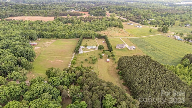 bird's eye view with a rural view and a wooded view