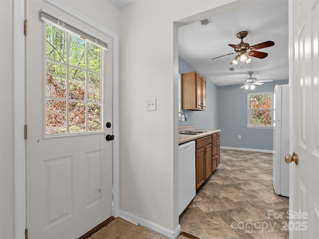 66 Avondale Heights Rd, Asheville, NC 28803 - kitchen with white appliances, a ceiling fan, brown cabinets, and stone finish flooring