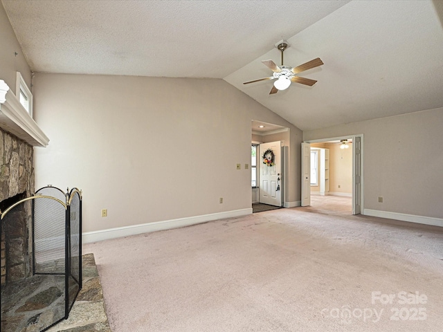 2919 Peachwood Ct, Fort Mill, SC 29715 - unfurnished living room with ceiling fan, light colored carpet, vaulted ceiling, baseboards, and a fireplace