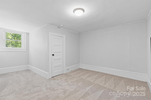 bonus room featuring baseboards and carpet