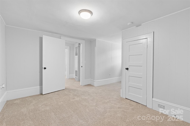 carpeted spare room with baseboards
