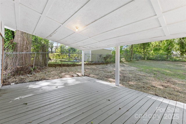 wooden terrace with a fenced backyard