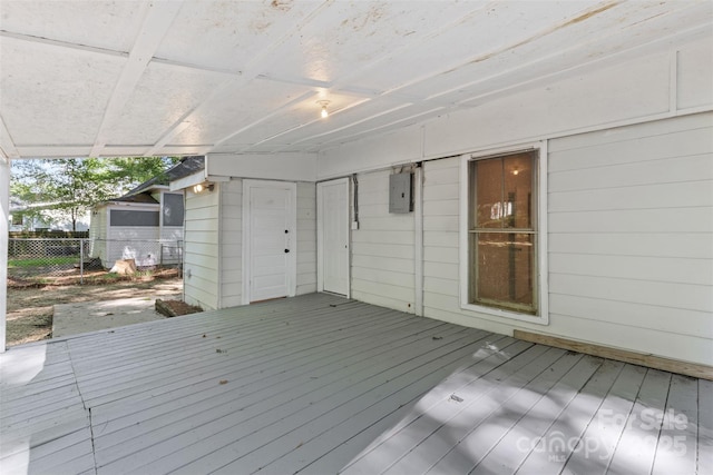 deck featuring electric panel and fence