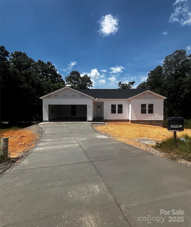 view of front of house featuring concrete driveway and an attached garage