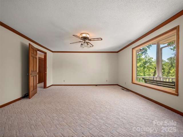 unfurnished room featuring ornamental molding, a ceiling fan, and light colored carpet