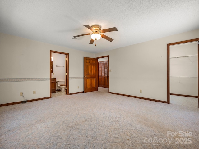 empty room featuring a ceiling fan, baseboards, and light colored carpet