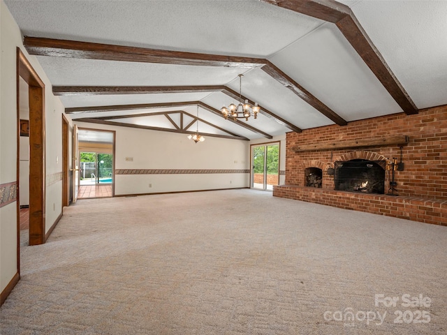 unfurnished living room featuring a wealth of natural light, a fireplace, a textured ceiling, and a notable chandelier
