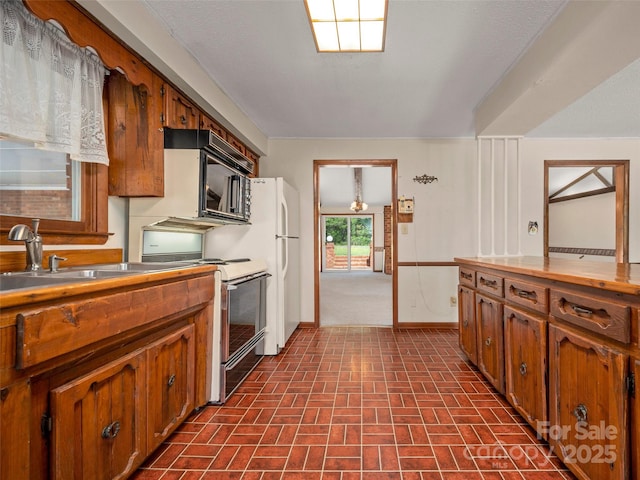 kitchen featuring white range oven, brown cabinets, a sink, baseboards, and brick patterned floor
