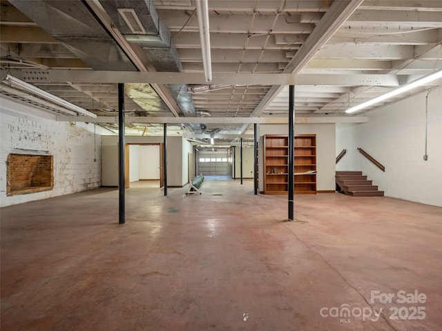 unfinished basement with visible vents and stairway