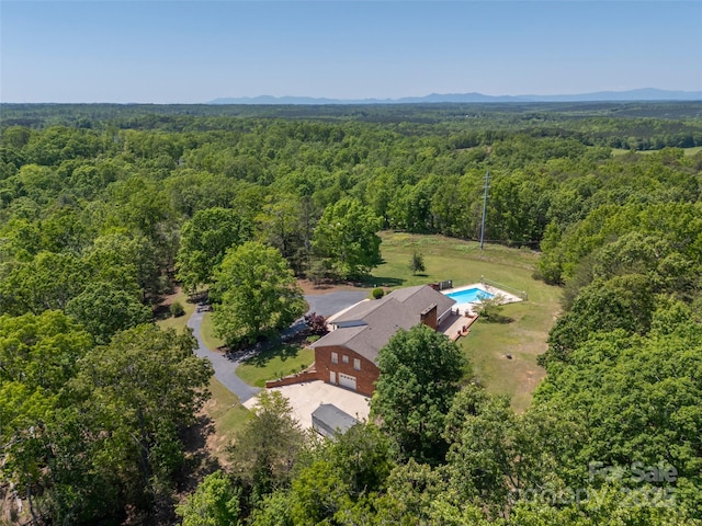 drone / aerial view featuring a forest view