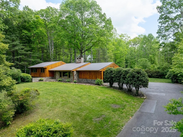 100 Ashton Ln, Brevard, NC 28712 - view of front of home featuring a front yard, board and batten siding, metal roof, stone siding, and a chimney