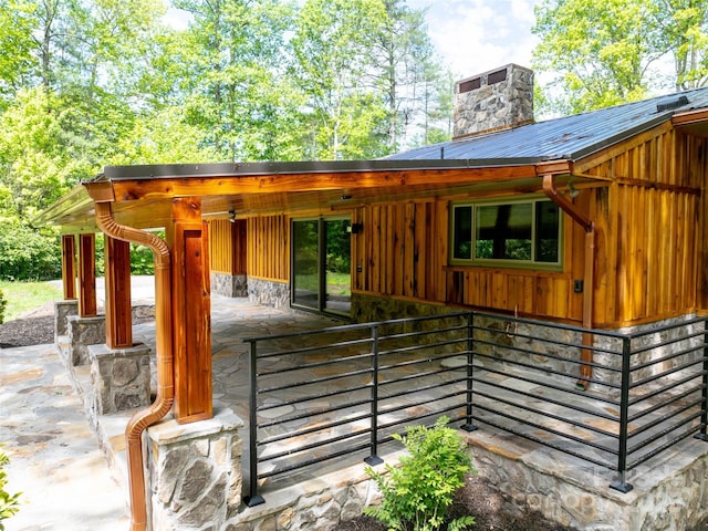 100 Ashton Ln, Brevard, NC 28712 - view of exterior entry featuring a chimney, board and batten siding, a patio, and stone siding