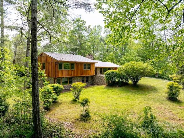 100 Ashton Ln, Brevard, NC 28712 - view of front of home with stone siding, a chimney, a front lawn, and board and batten siding
