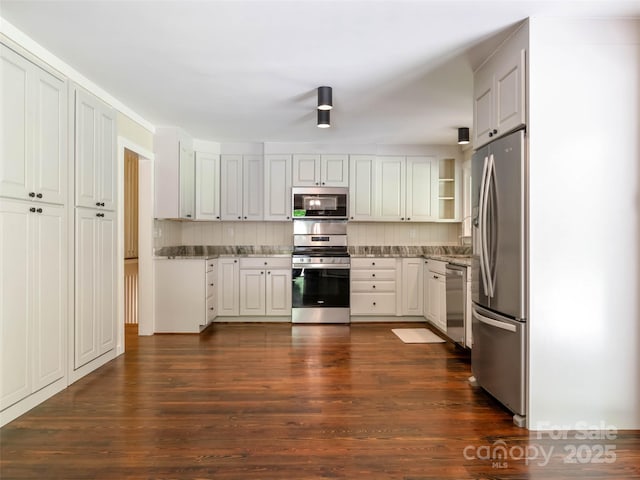 100 Ashton Ln, Brevard, NC 28712 - kitchen featuring stainless steel appliances, dark wood-type flooring, light stone countertops, and white cabinetry
