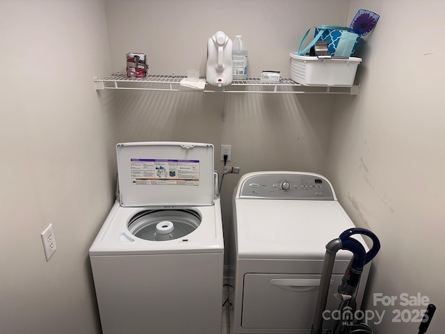 laundry area featuring separate washer and dryer and laundry area
