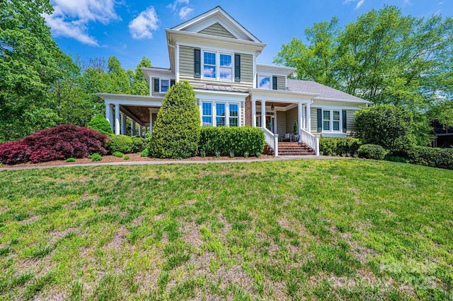 traditional home with covered porch and a front lawn
