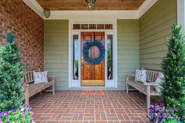 doorway to property featuring covered porch