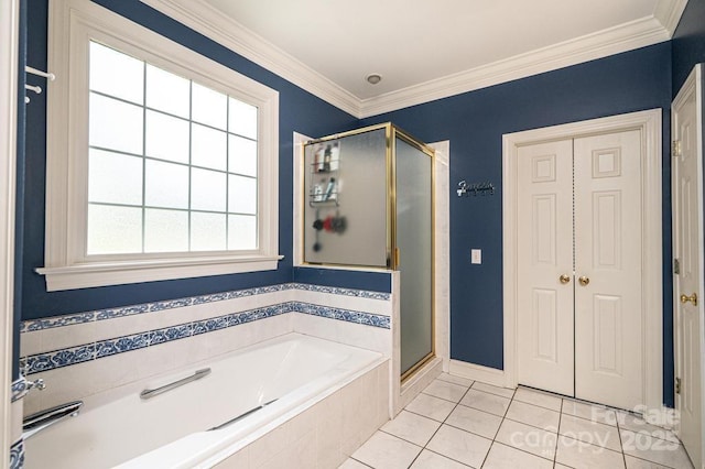 bathroom with tile patterned floors, ornamental molding, a shower stall, and a garden tub