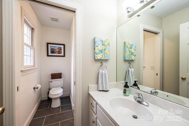 bathroom featuring vanity, toilet, tile patterned floors, baseboards, and visible vents