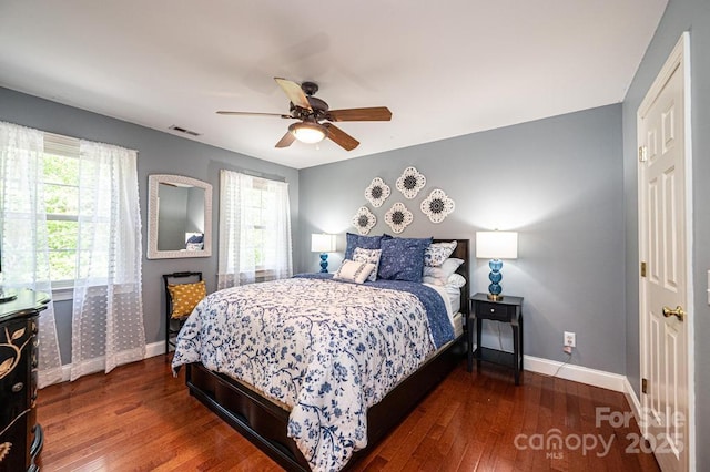 bedroom featuring visible vents, a ceiling fan, baseboards, and wood-type flooring