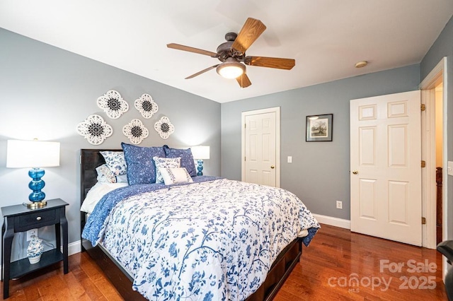 bedroom featuring baseboards, a ceiling fan, and wood finished floors