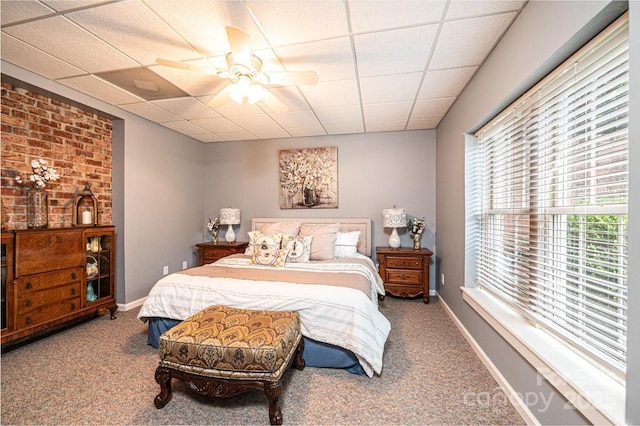 carpeted bedroom featuring baseboards, a ceiling fan, and a paneled ceiling