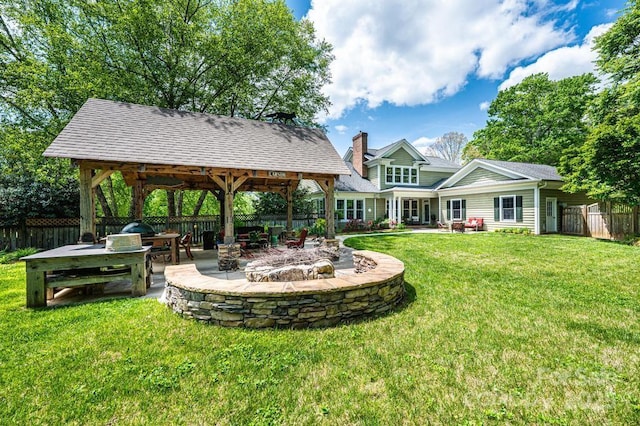 view of yard featuring a gazebo, a fire pit, fence, and a patio area