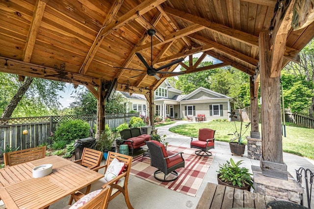 view of patio / terrace with a gazebo, an outdoor living space, a fenced backyard, and ceiling fan