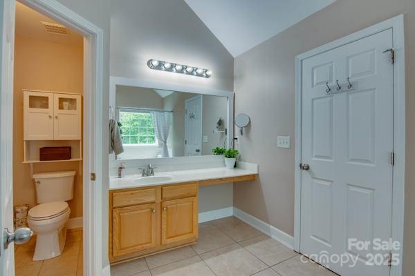 136 Elba Dr, Mooresville, NC 28115 - full bathroom with lofted ceiling, vanity, and tile patterned floors