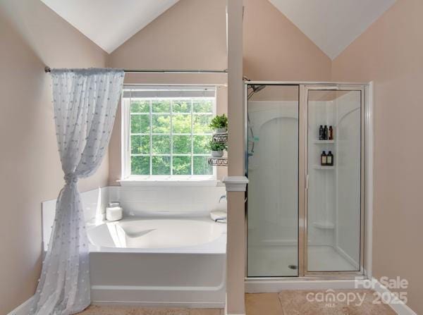 136 Elba Dr, Mooresville, NC 28115 - full bathroom with vaulted ceiling, a shower stall, a garden tub, and tile patterned flooring