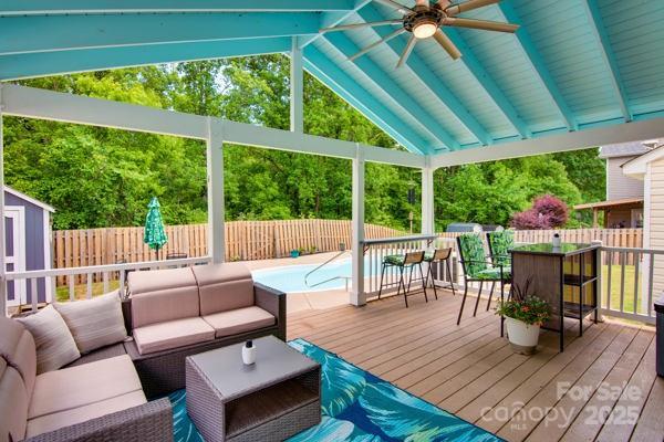 136 Elba Dr, Mooresville, NC 28115 - deck featuring an outdoor hangout area, a ceiling fan, a fenced backyard, and a storage unit