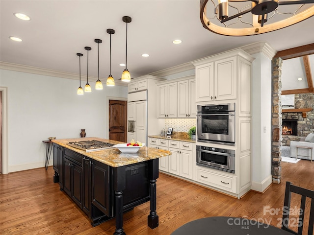 714 Wickhams Fancy Dr, Biltmore Lake, NC 28715 - kitchen with tasteful backsplash, ornamental molding, light stone counters, white cabinetry, and appliances with stainless steel finishes