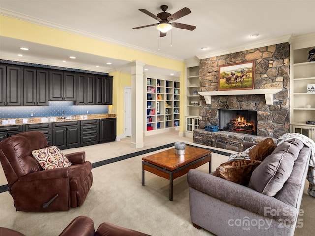 714 Wickhams Fancy Dr, Biltmore Lake, NC 28715 - living area featuring ornate columns, ceiling fan, a stone fireplace, light colored carpet, and ornamental molding
