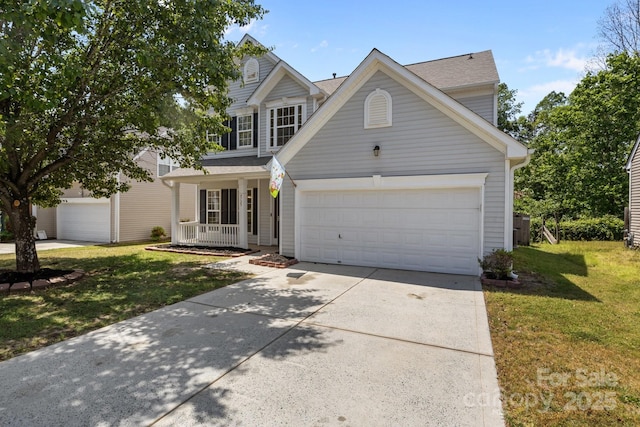 traditional-style home with covered porch, an attached garage, concrete driveway, and a front yard