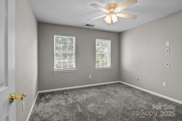 unfurnished room with baseboards, visible vents, and carpet
