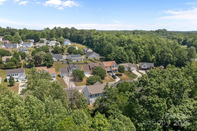 bird's eye view featuring a residential view and a forest view