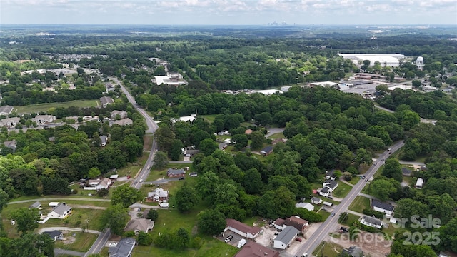 drone / aerial view featuring a forest view