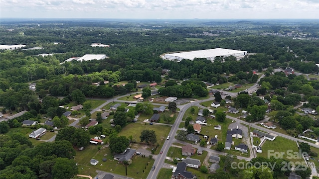 birds eye view of property featuring a wooded view