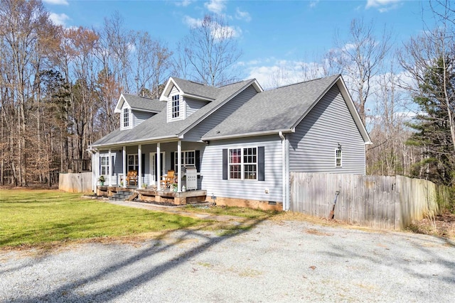 new england style home featuring a porch, crawl space, roof with shingles, fence, and a front lawn