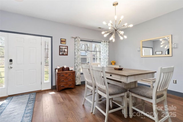 dining area featuring an inviting chandelier, dark wood finished floors, and visible vents