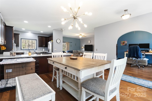 dining area featuring an inviting chandelier, recessed lighting, and dark wood-style floors